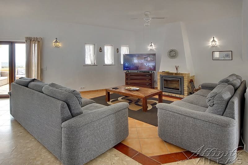 Casa das Rochas living room with fireplace